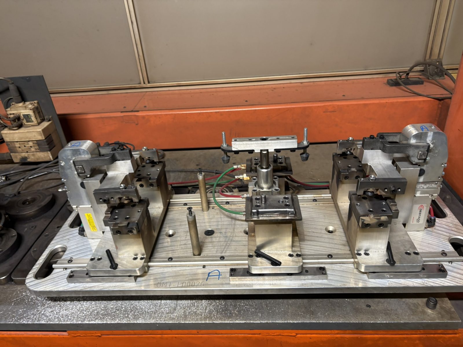 Clamping fixture with pneumatic clamps mounted on a base plate